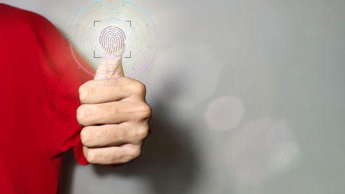 Close-up of hand holding light bulb