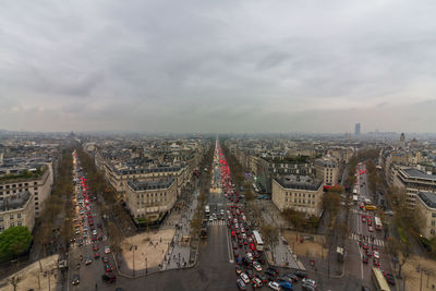 High angle view of city street against cloudy sky