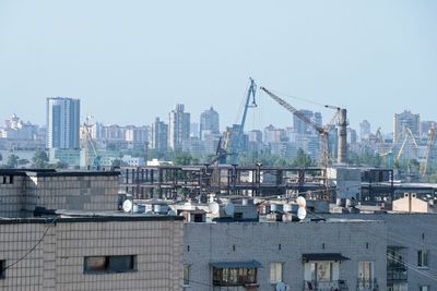 Buildings in city against clear sky