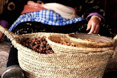 Close-up of man preparing food in basket