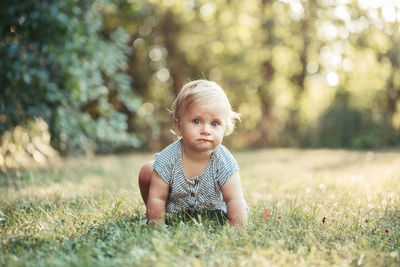 Portrait of cute girl crawling at park