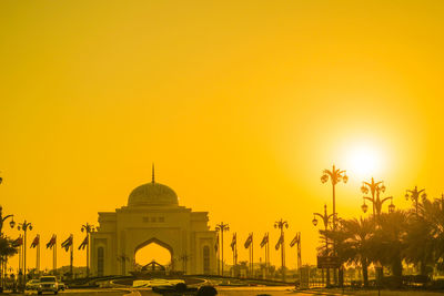 Low angle view of church against orange sky