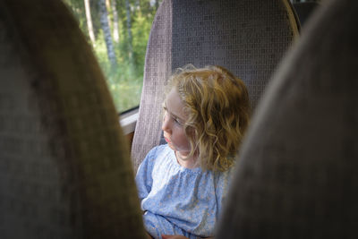 Portrait of cute girl by tree trunk