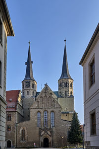 Low angle view of buildings against clear blue sky