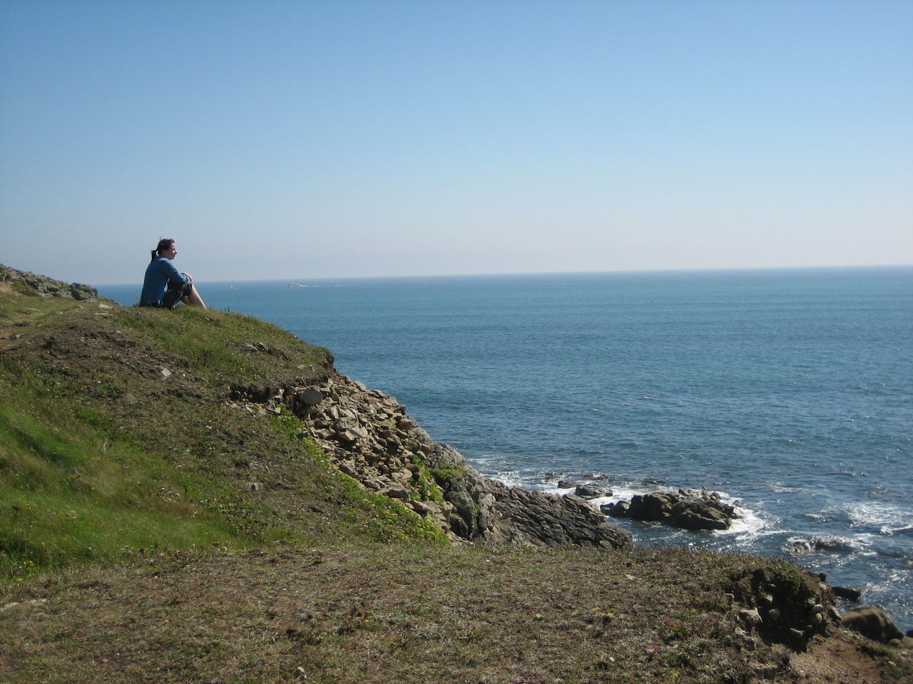 MAN STANDING ON SHORE AGAINST CLEAR SKY