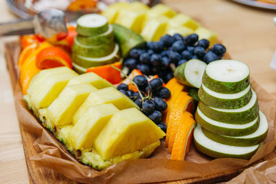 Sliced fruits. healthy eating concept. pieces of pineapple, pear, oranges and grapes.