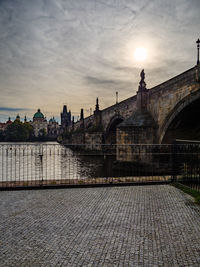 View of bridge over river against cloudy sky