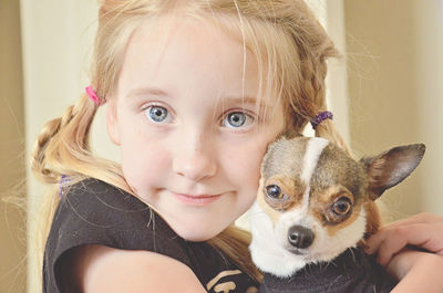 Close-up portrait of cute girl with chihuahua