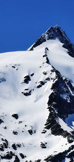 Scenic view of snowcapped mountains against clear blue sky