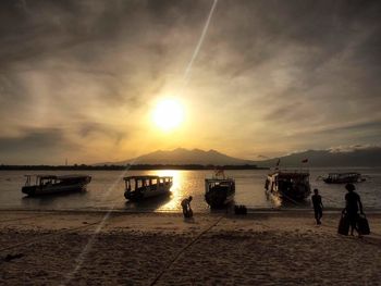 Scenic view of sea against cloudy sky during sunset