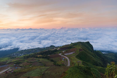 High angle view of winding road against cloudy sky