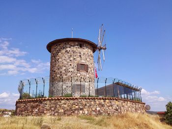 Low angle view of castle on field against sky