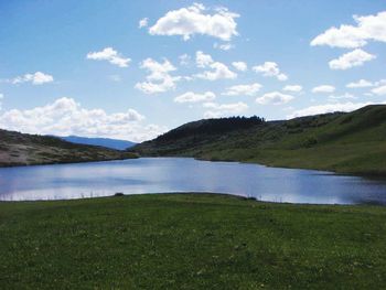 Scenic view of lake against cloudy sky