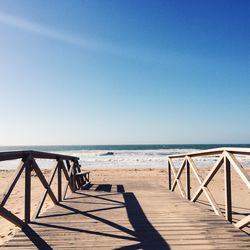 Pier on sea against clear sky