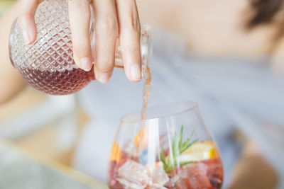 Midsection of woman holding drink