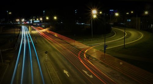 High angle view of light trails on road at night