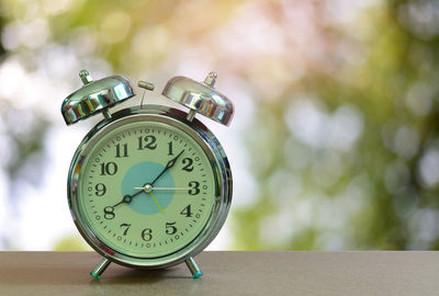 Close-up of clock on table