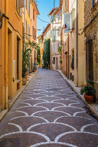 Footpath amidst buildings in city