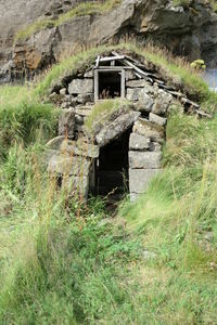 Abandoned house on field