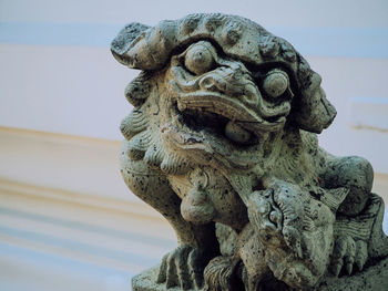 Low angle view of animal statue against sky