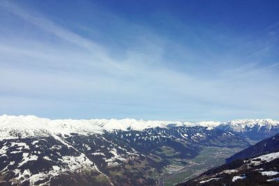 Scenic view of snowcapped mountains against cloudy sky