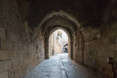 Empty alley amidst buildings in city