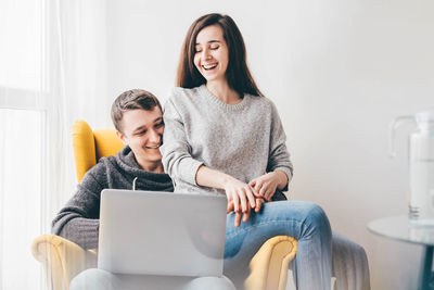 Young woman using laptop at home