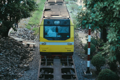 View of railroad tracks by trees in city