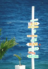 Warning sign on wooden post
