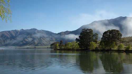 Scenic view of lake and mountains against sky