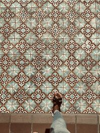 Rear view of young woman standing against window