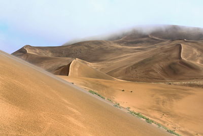 1175 tall megadune ridges overlook the e.shore of sumu barun jaran lake. badain jaran desert-china.