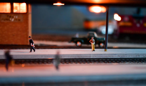 People walking on toy train set street