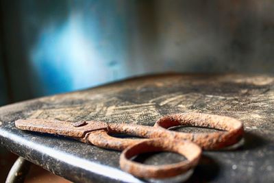 Close-up of rusty scissor on table