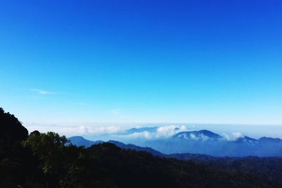 Scenic view of mountains against blue sky