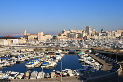 High angle view of harbor and buildings in city