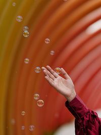 Hands playing with bubbles