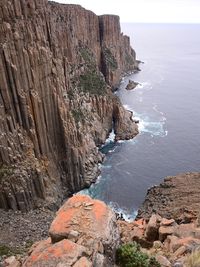 Rock formations by sea against sky