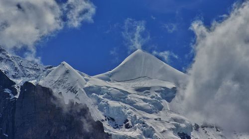 Scenic view of snow covered mountains against sky