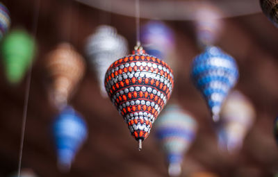 Close-up of illuminated lighting equipment hanging on ceiling