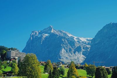 Scenic view of snowcapped mountains against clear blue sky