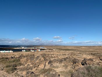 Scenic view of land against blue sky