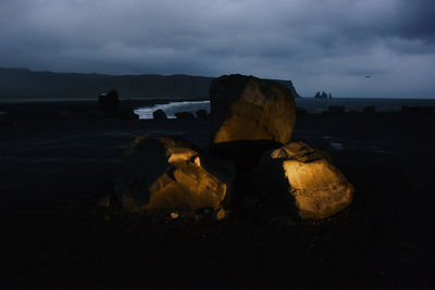 Rocks on beach against sky