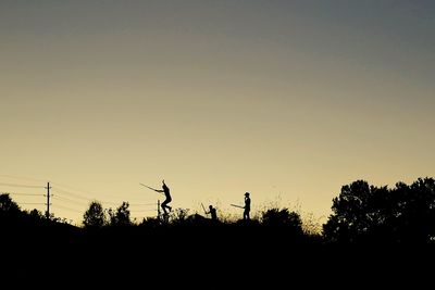 Silhouette of trees against sky at sunset