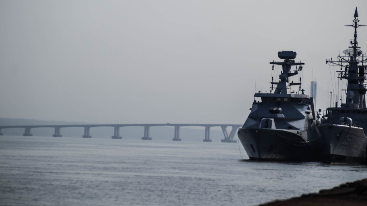 water, transportation, sea, nautical vessel, sky, ship, nature, mode of transportation, vehicle, navy, destroyer, architecture, watercraft, no people, built structure, bridge, copy space, pier, battleship, outdoors, fog, naval ship, guided missile destroyer, warship, day, beach, environment, travel, industry, ocean