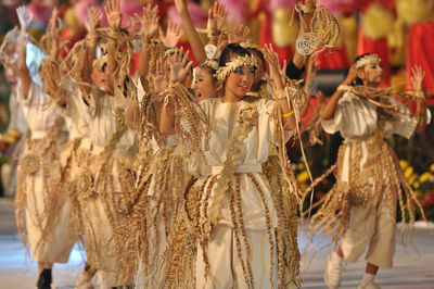 Smiling artists performing traditional dance during carnival