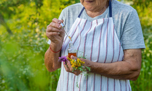 Midsection of man holding plant