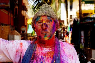 Portrait of man wearing multi colored mask