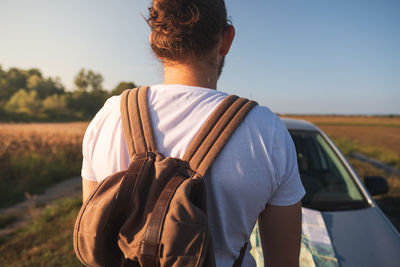 Rear view of man against sky