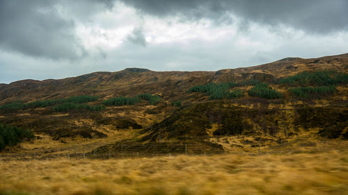 Scenic view of landscape against cloudy sky